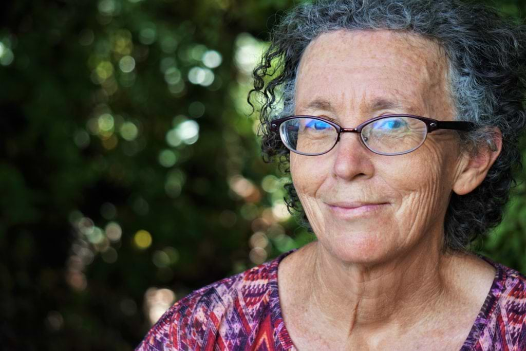 Menopause and anxiety: An older woman wearing glasses looks at the camera