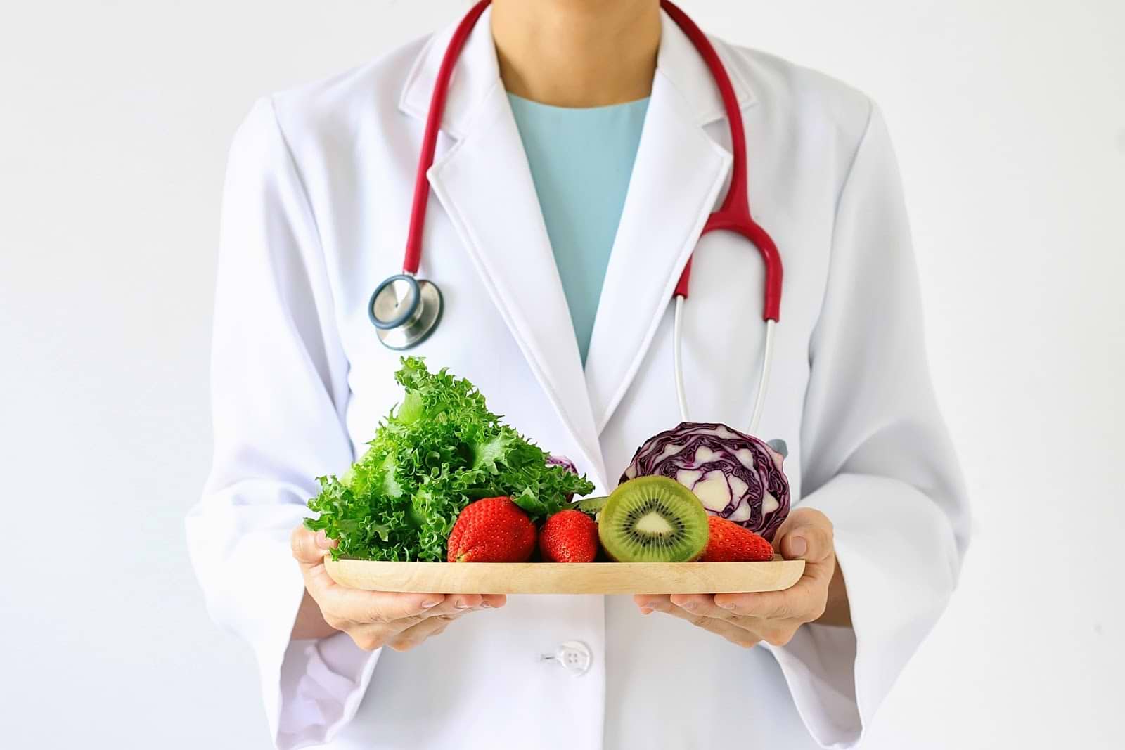 Symptoms of Low Estrogen: Doctor holding healthy food