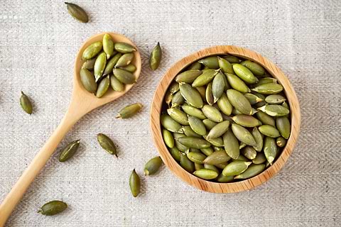 green pumpkin seeds in a bowl