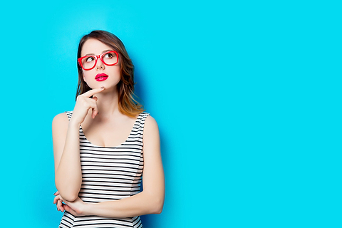 Woman thinking with red glasses on