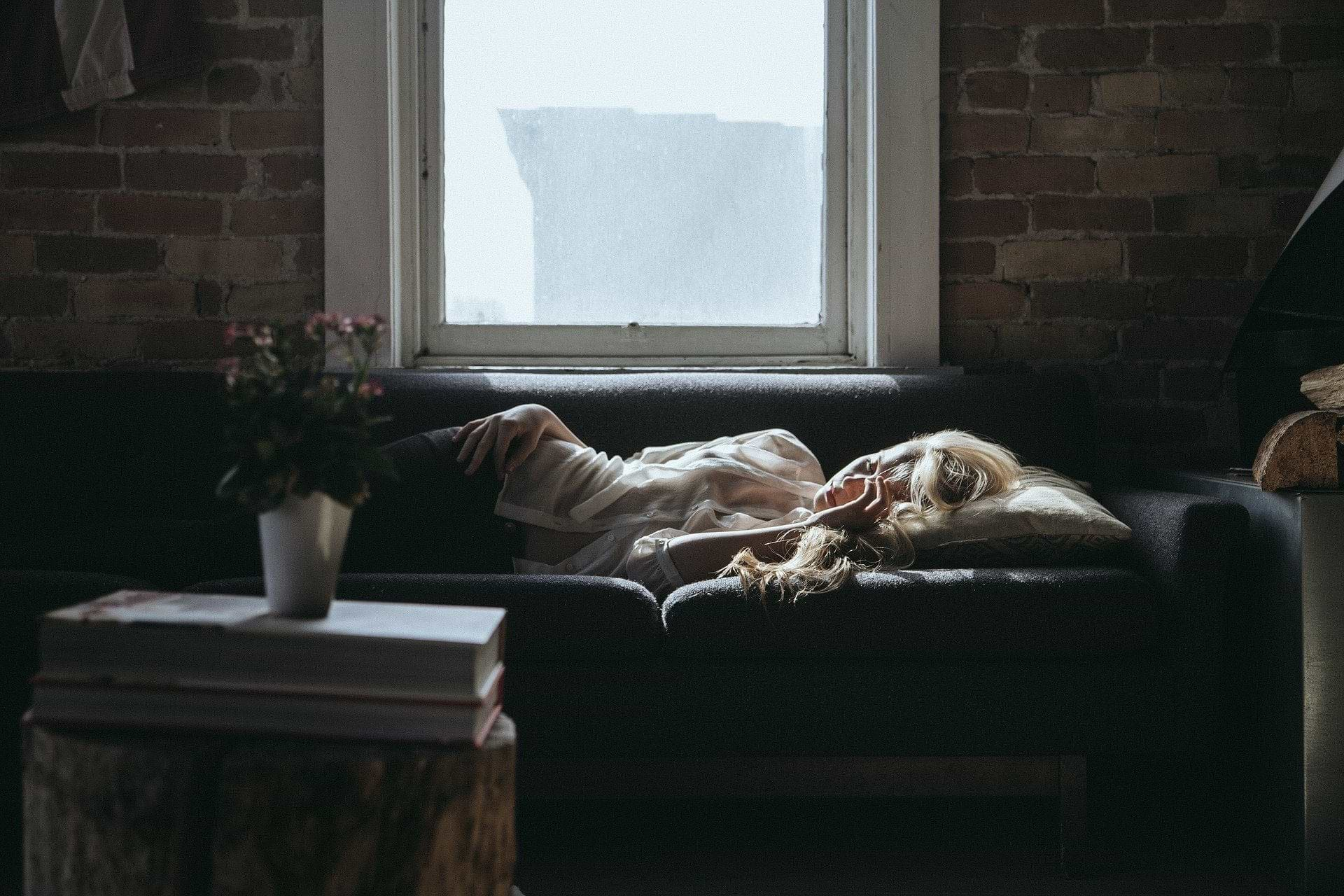 Perimenopause supplements: A woman sleeps on a couch