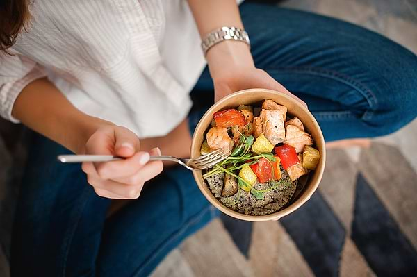 Woman eating healthily to achieve natural hormone balance for PMS