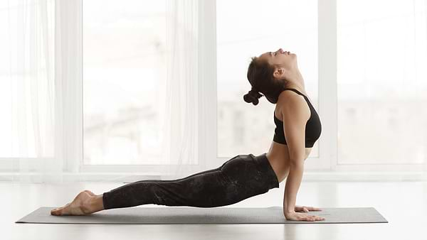 Woman practising yoga to lower her stress and hormonal imbalance symptoms