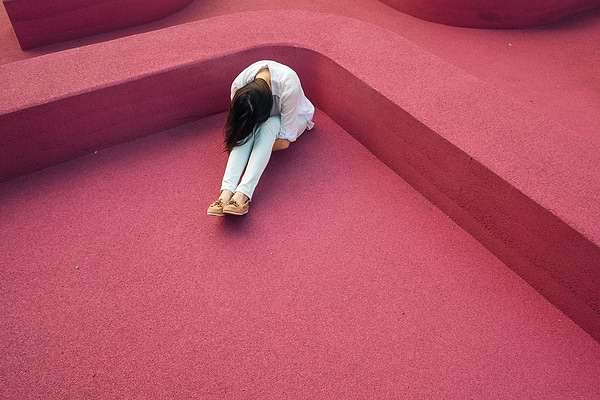 Gut rot: A woman sits with her head on her knees