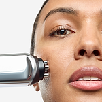 Woman using CurrentBody RF radio frequency skin tightening device on face for anti-aging treatment