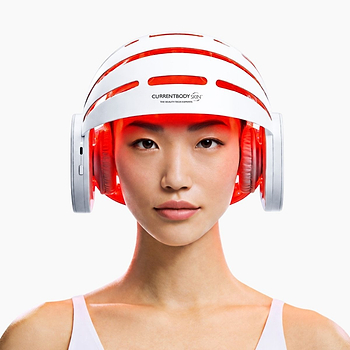 Woman using CurrentBody LED Hair Growth Helmet on her head