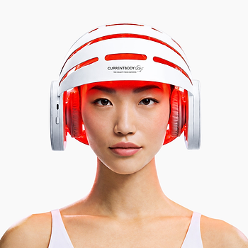 Woman using CurrentBody LED Hair Growth Helmet on her head