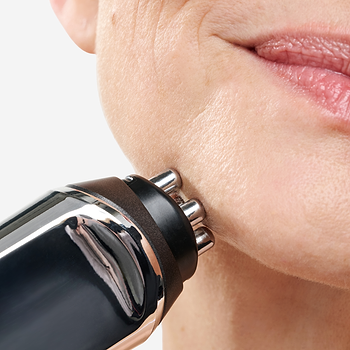 Close-up of CurrentBody RF skin tightening device being applied to jawline