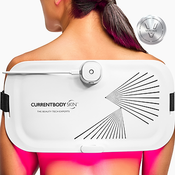 Woman wearing the CurrentBody Skin LED Light Therapy Panel on her back.