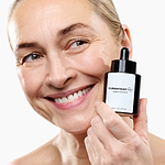 Woman holding the CurrentBody Skin Green Tea Serum