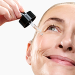 Woman applying the CurrentBody Skin Green Tea Serum