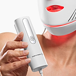 Woman holding the controller of the Series 2 Red Light Therapy Face Mask