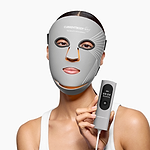 Woman holding the CurrentBody Skin LED Multi-Light Mask controller showing the different modes