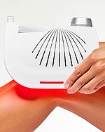 Woman using the LED Light Therapy Panel on her knees