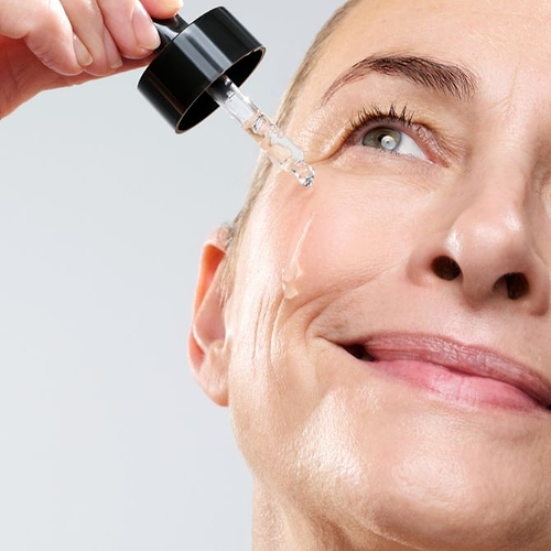 Woman using's the CurrentBody Green Tea Serum