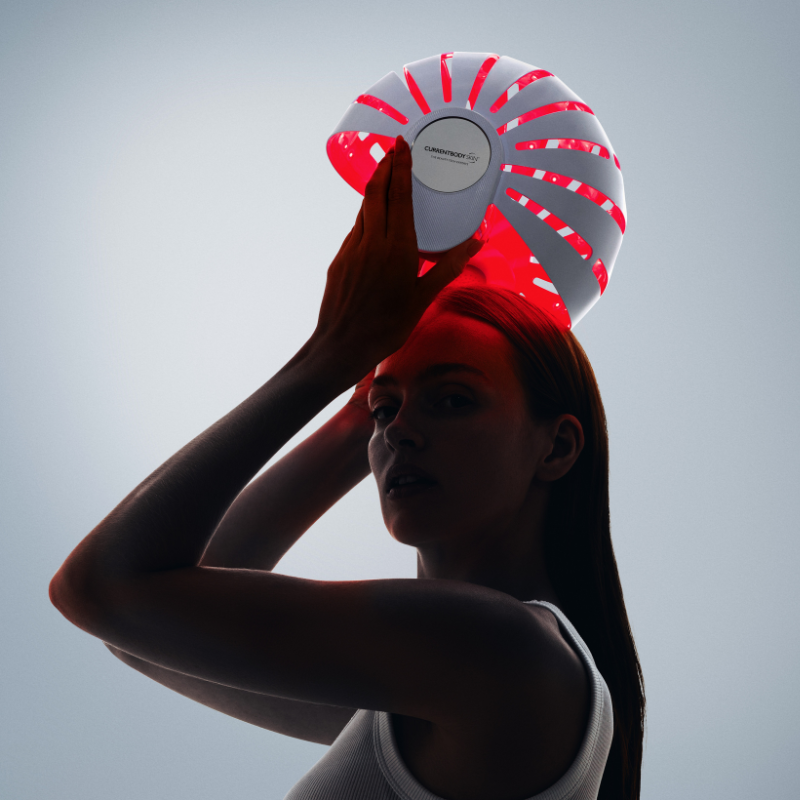 Woman in the anagen phase about to use an LED hair growth helmet for hair growth