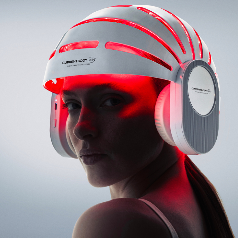 Woman wearing the CurrentBody LED hair growth helmet for hair loss