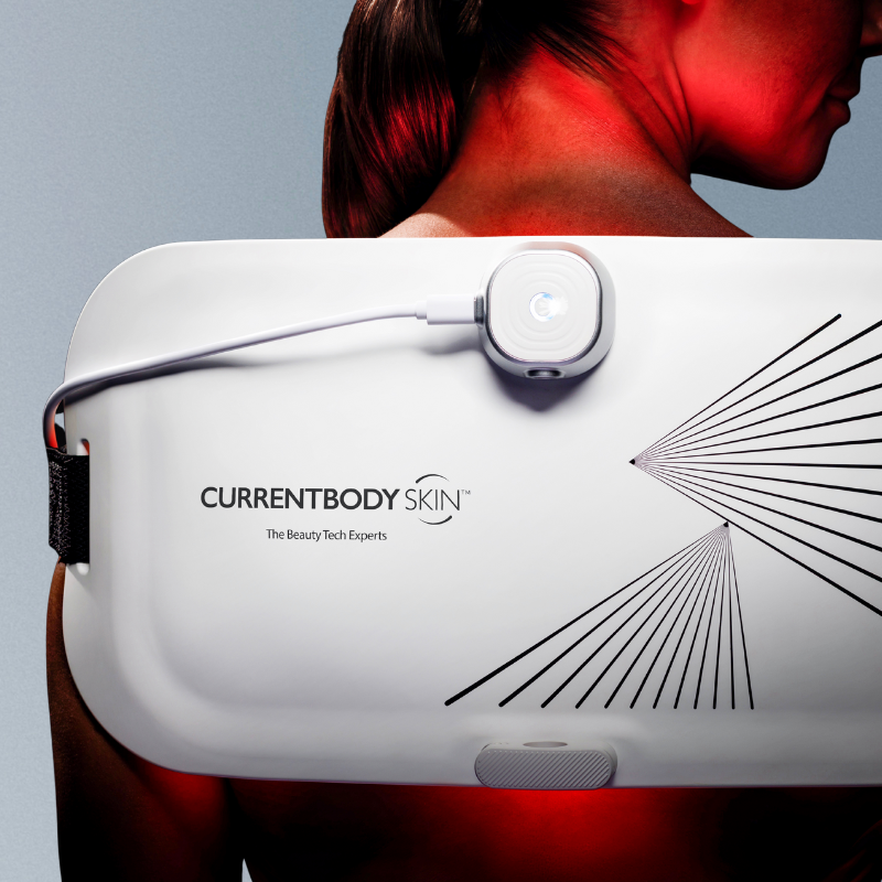 Woman using the Currentbody LED light therapy panel to boost collagen production