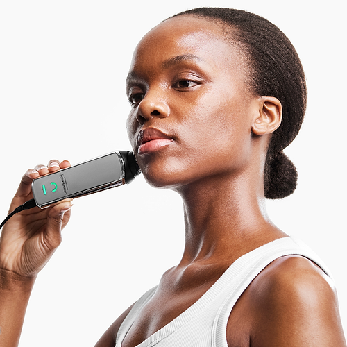 Woman using CurrentBody RF radio frequency skin tightening device on face for anti-aging treatment