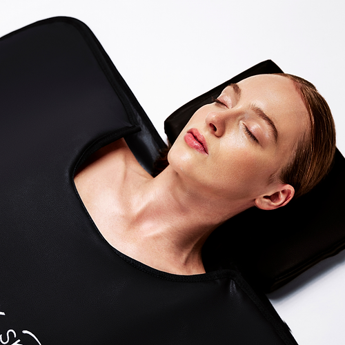 woman lying in the currentbody sauna blanket