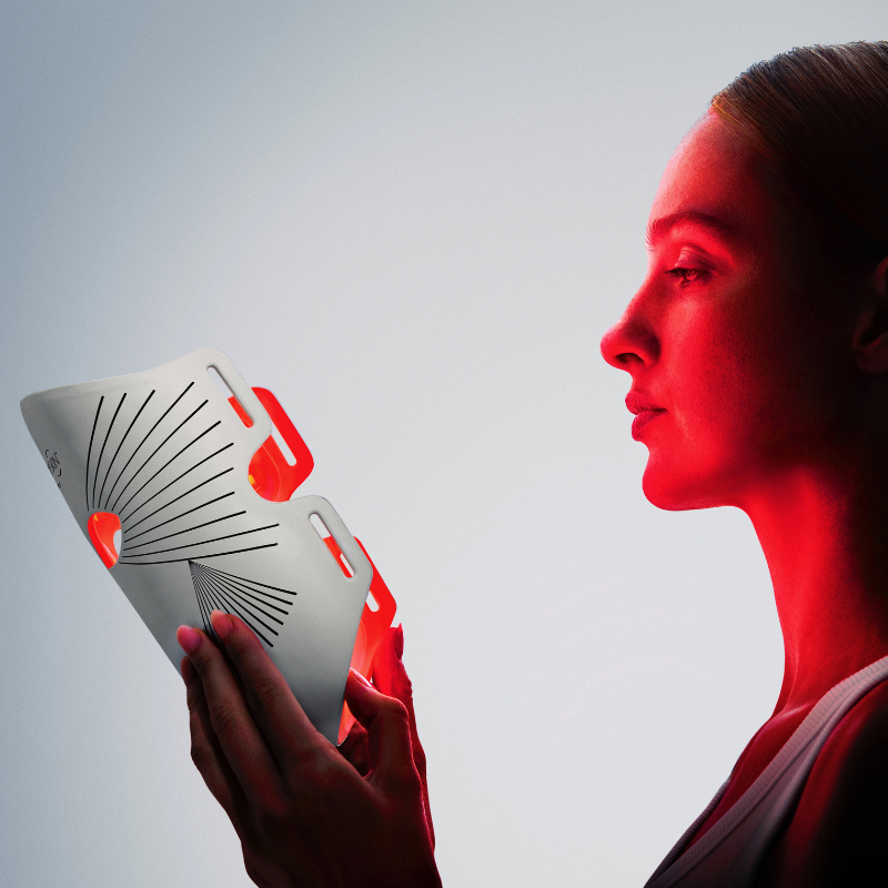 Woman glowing using an led face mask