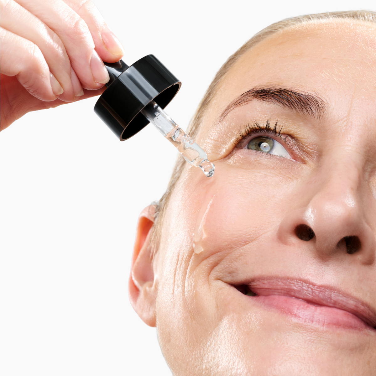 Woman applying the CurrentBody Skin Green Tea Serum