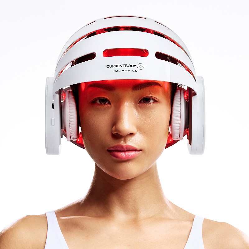 Woman wearing Currentbody LED Hair growth helmet