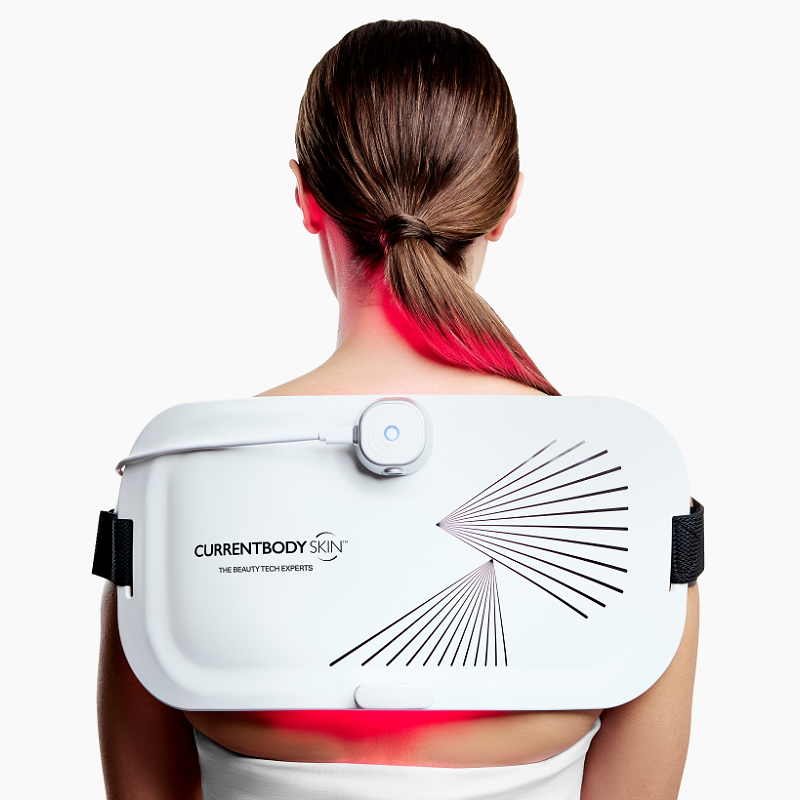 CurrentBody LED Light Therapy Panel on woman's back for pain relief and skin treatment