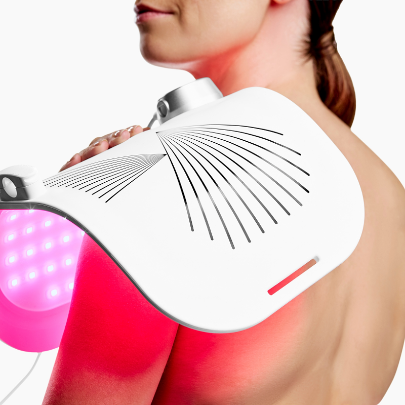 CurrentBody LED light therapy panel in use on a woman's shoulder