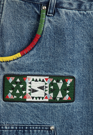 Close-up of Ashluxe Patch Denim Short showing embroidered ASH design.