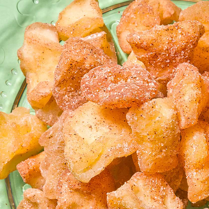 Apple pieces coated with cinnamon and sugar