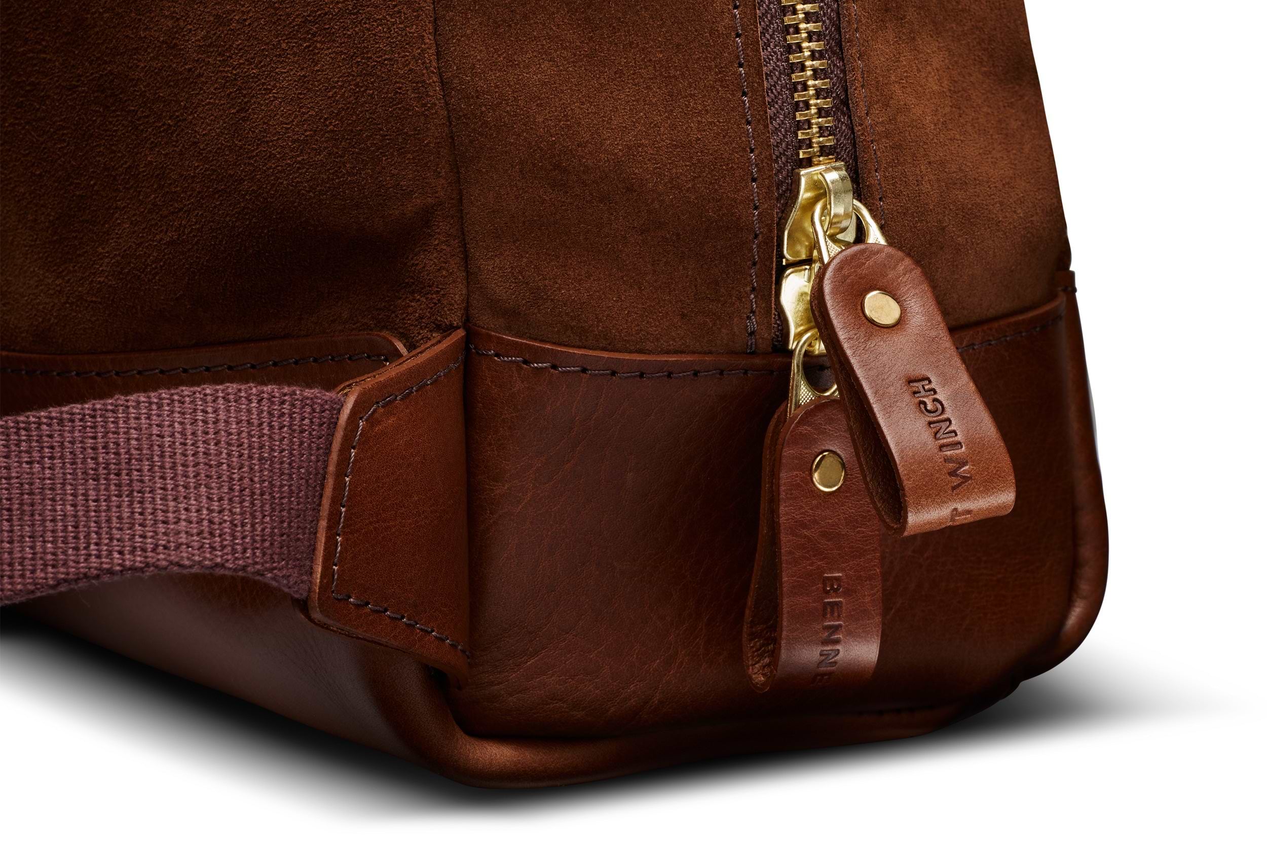 brown leather zipper fastener on brown suede backpack