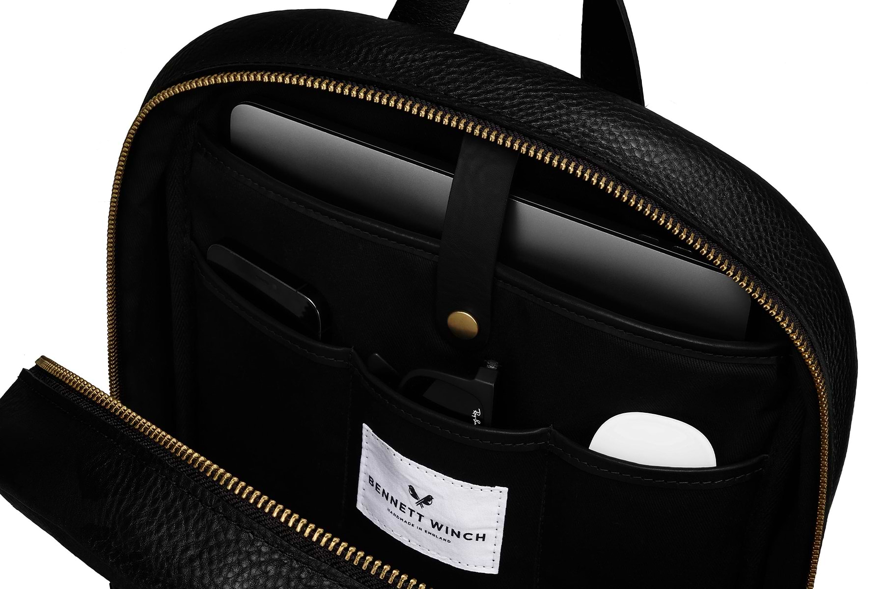 Close up on organizers compartments in black leather backpack