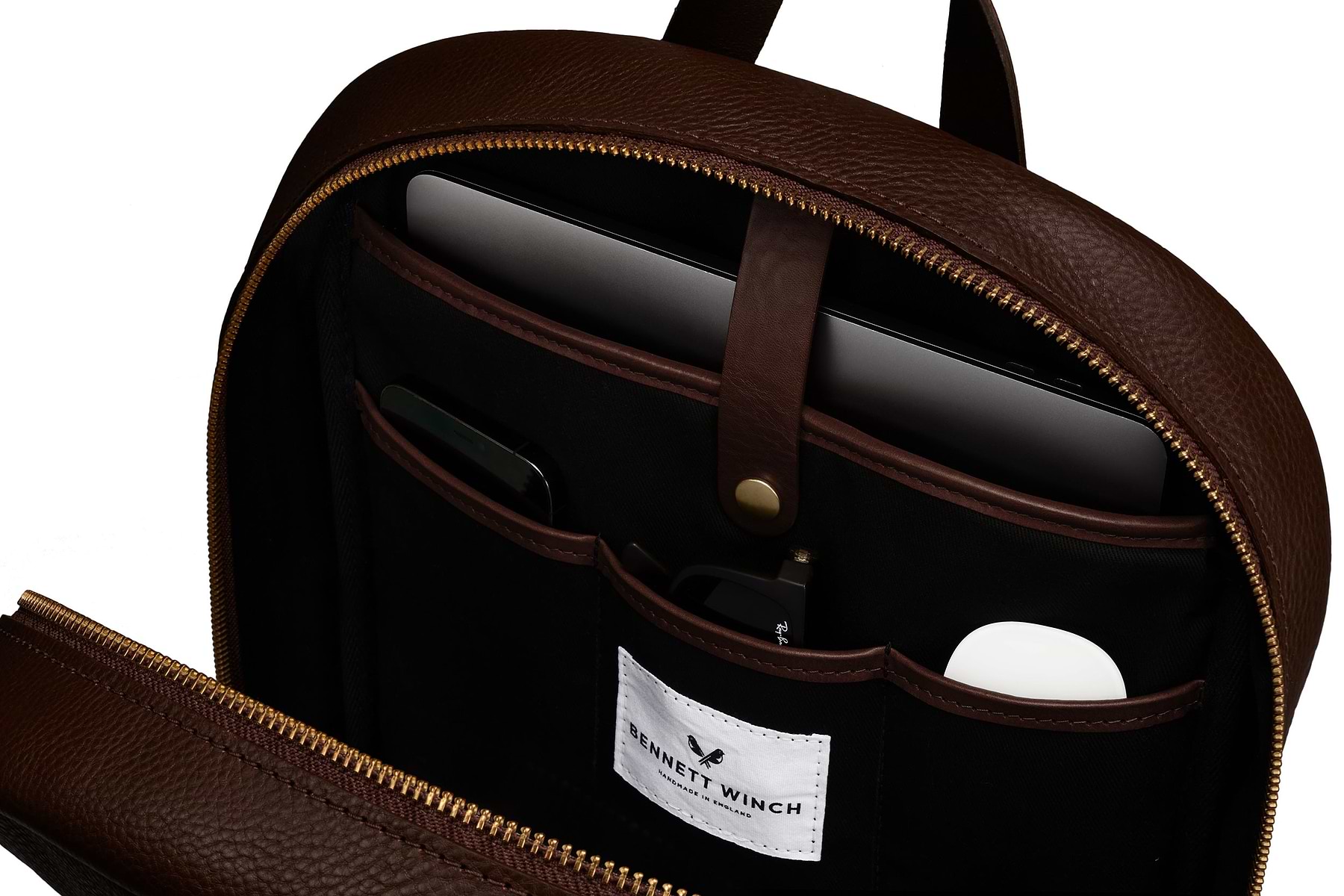 Close up on organizers compartments in high end brown leather backpack