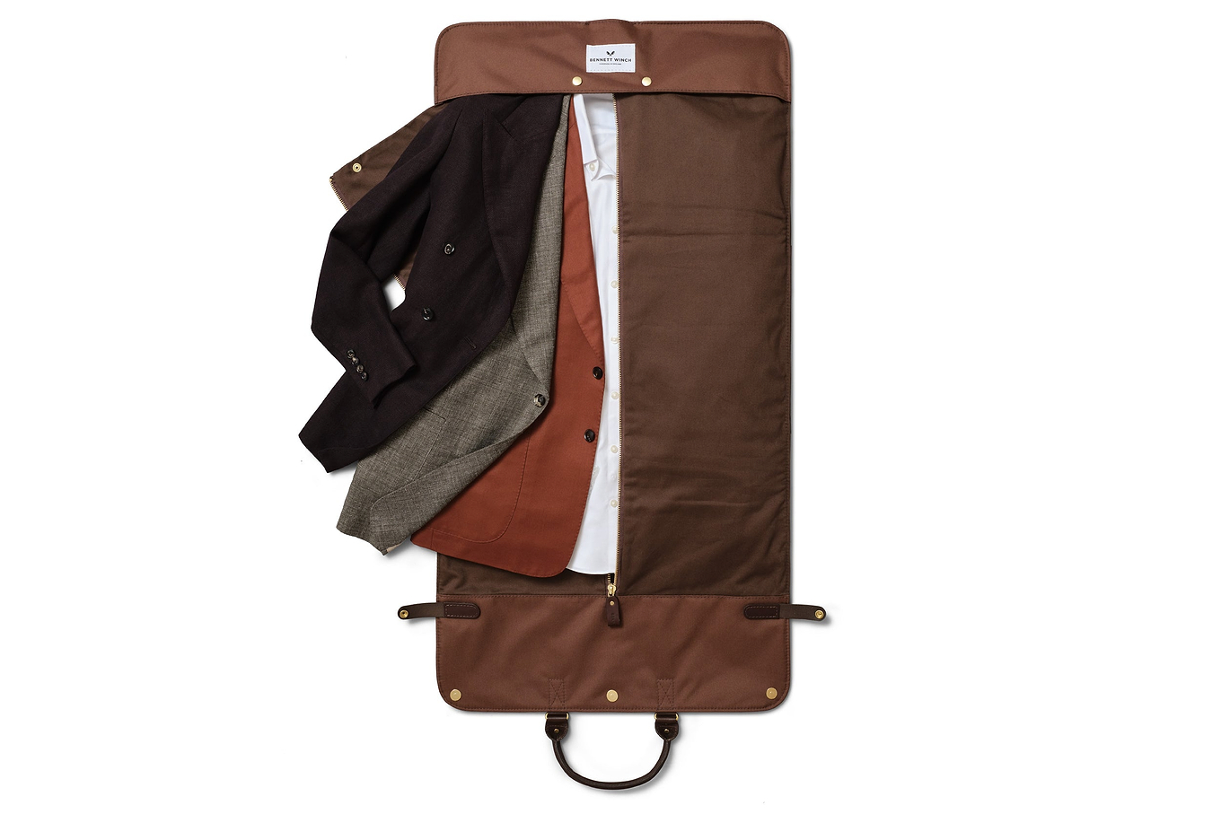 a top view of the brown leather trifold fully unzipped showcasing clothes inside 