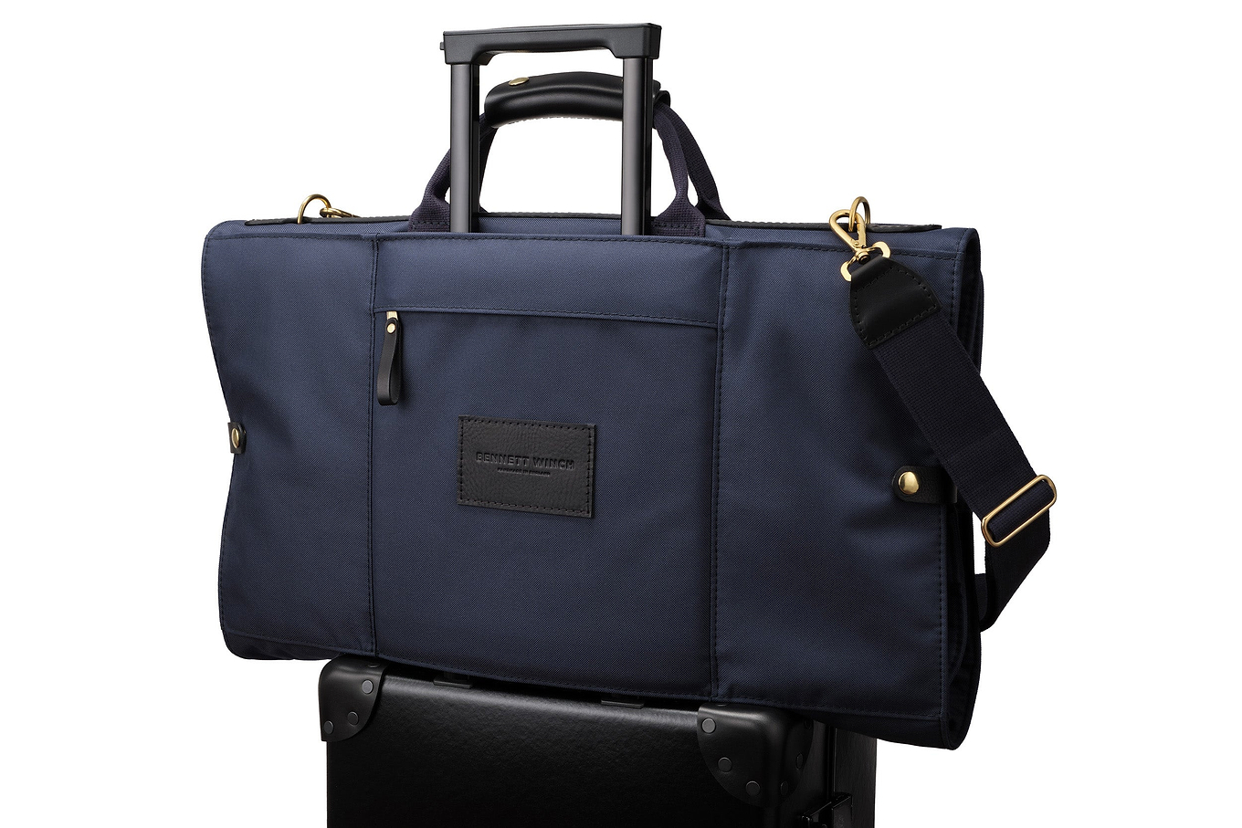 navy luxury trifold on top of luggage