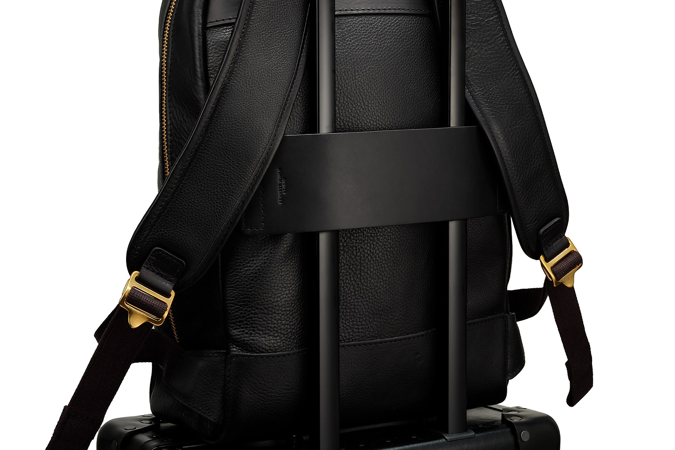 wide leather luggage strap on black leather backpack 
