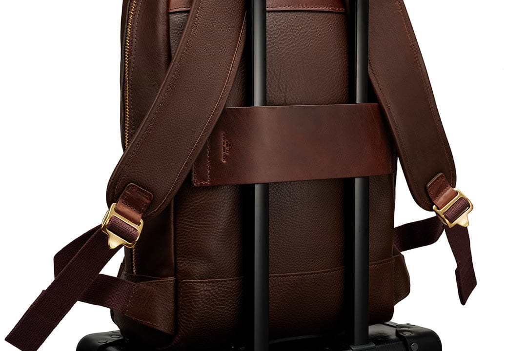 the thick leather luggage strap on the backpack 