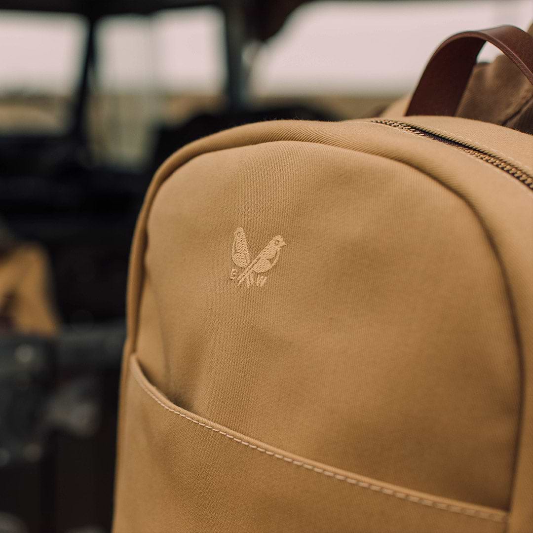 an action shot of the sand Bennett Winch backpack 