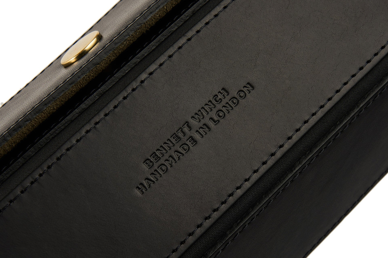 Close up view of the Bennett Winch logo on luxury black leather watch roll