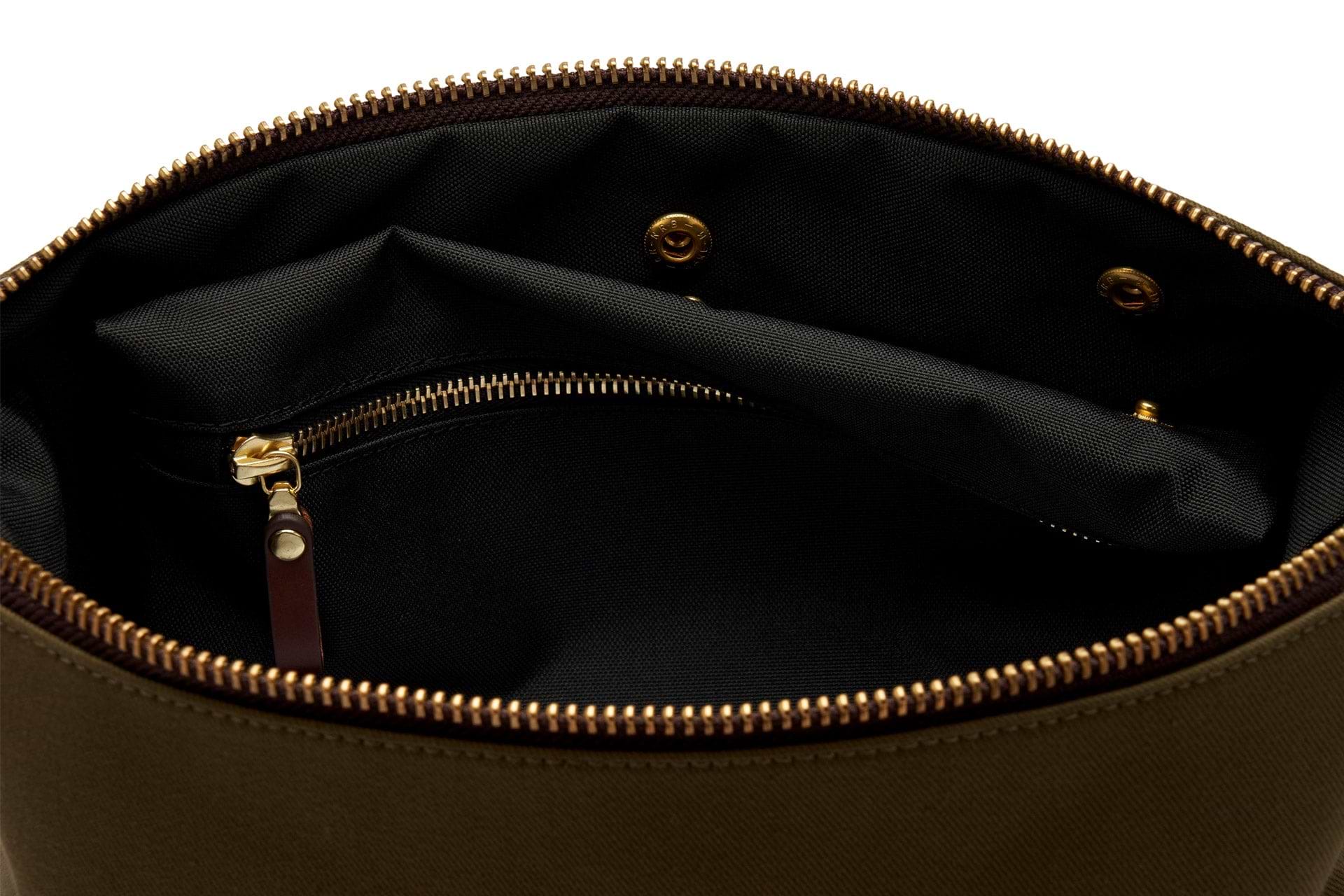 interior clip out wet compartment of green canvas dopp kit