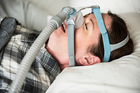 Woman with sleep apnea machice