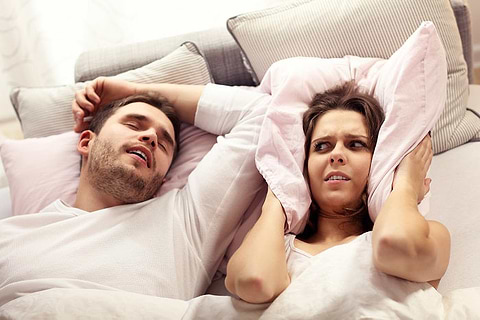 women annoyed by man snoring