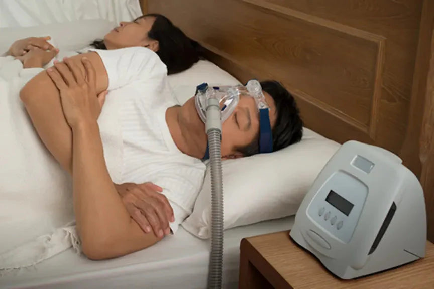 man sleeping with cpap machine