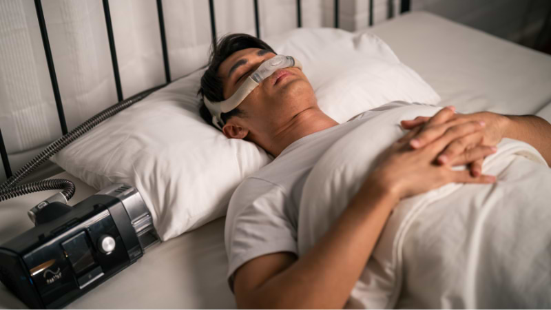 man sleeping using cpap machine