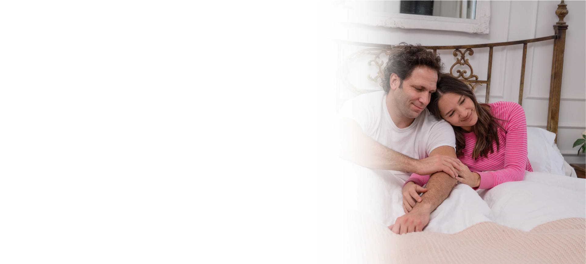 man and woman happy in bed
