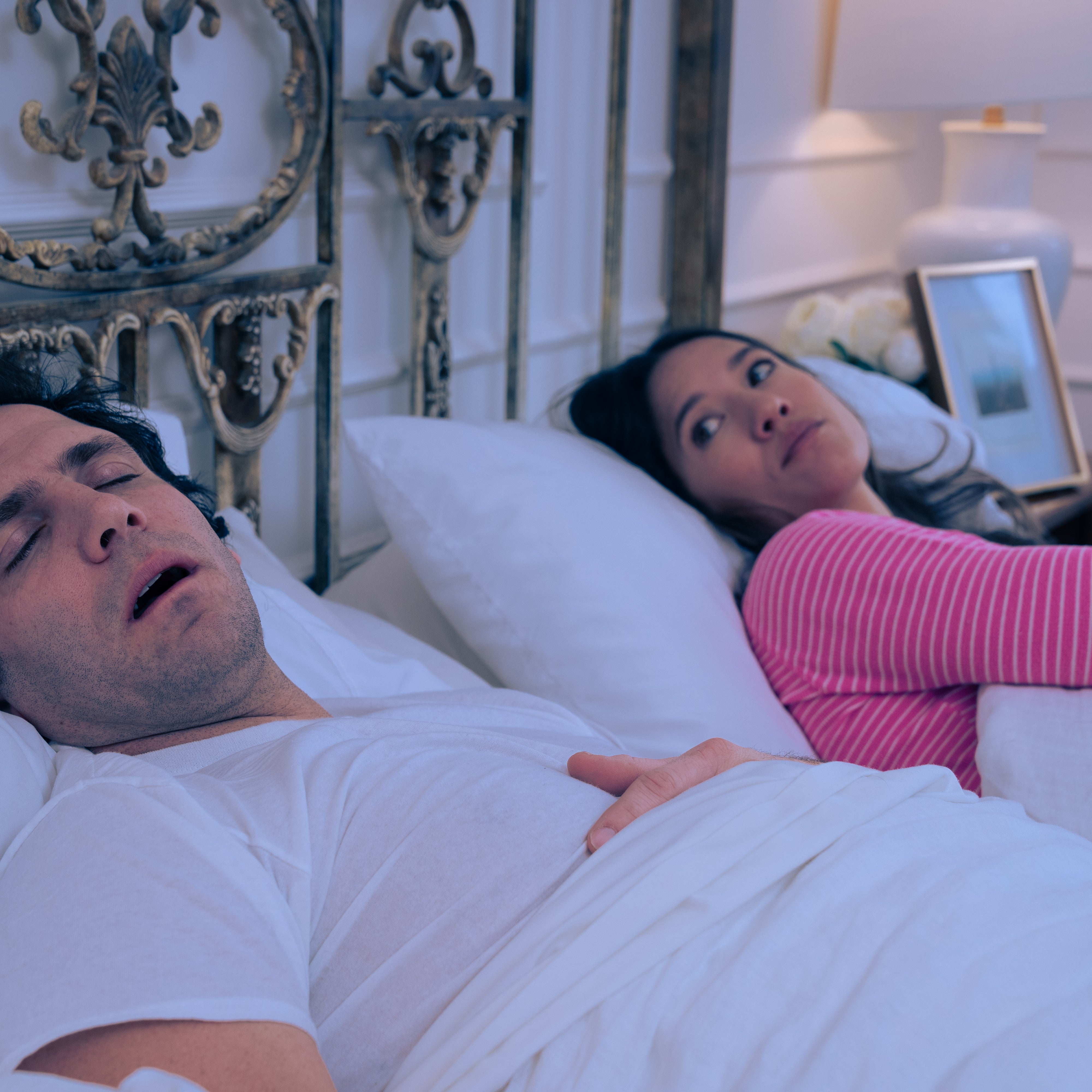 woman putting snoring device in mouth in kitchen after fitting