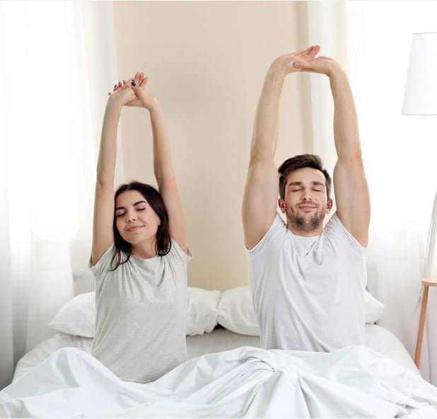 couple waking up in bed