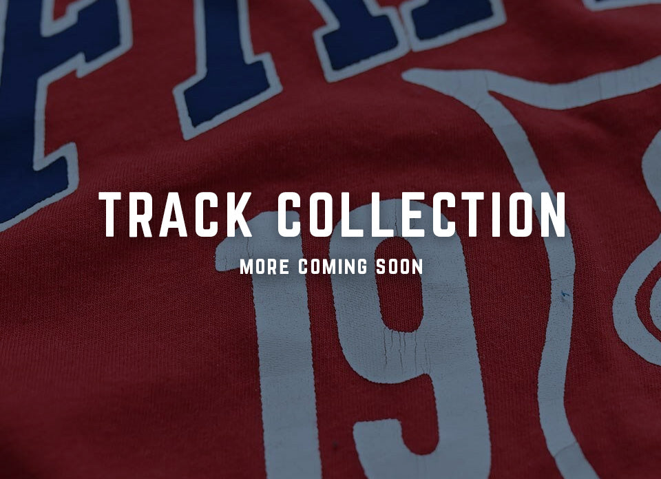 'Red and blue track collection shirt with 'More Coming Soon' text.'