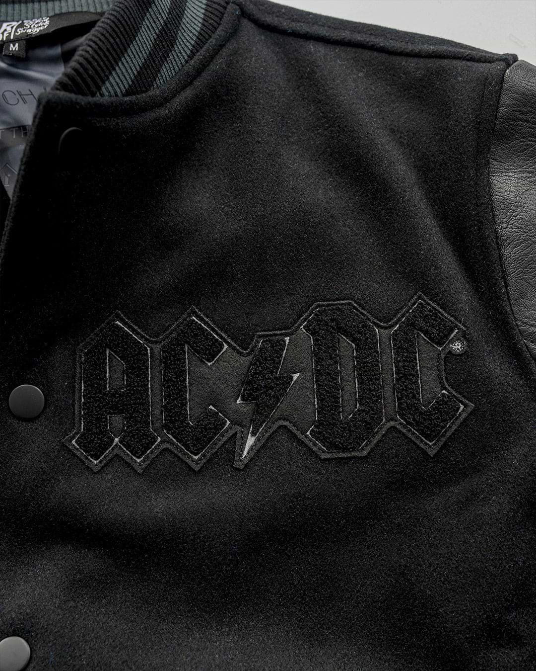 AC/DC Through The Eras Black Varsity Jacket - Roots of Fight